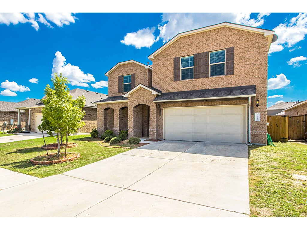 a front view of a house with a yard