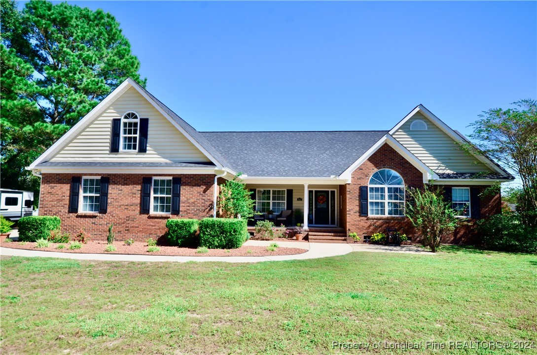 a front view of house with yard and green space