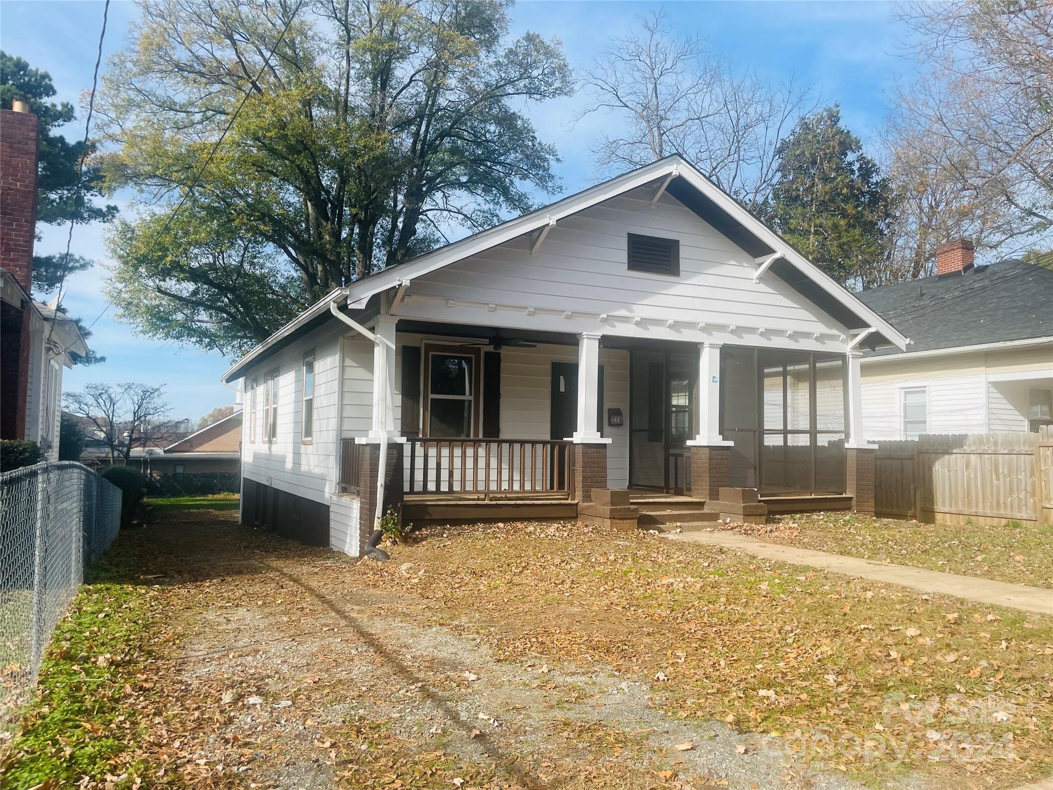 a front view of a house with yard and seating area