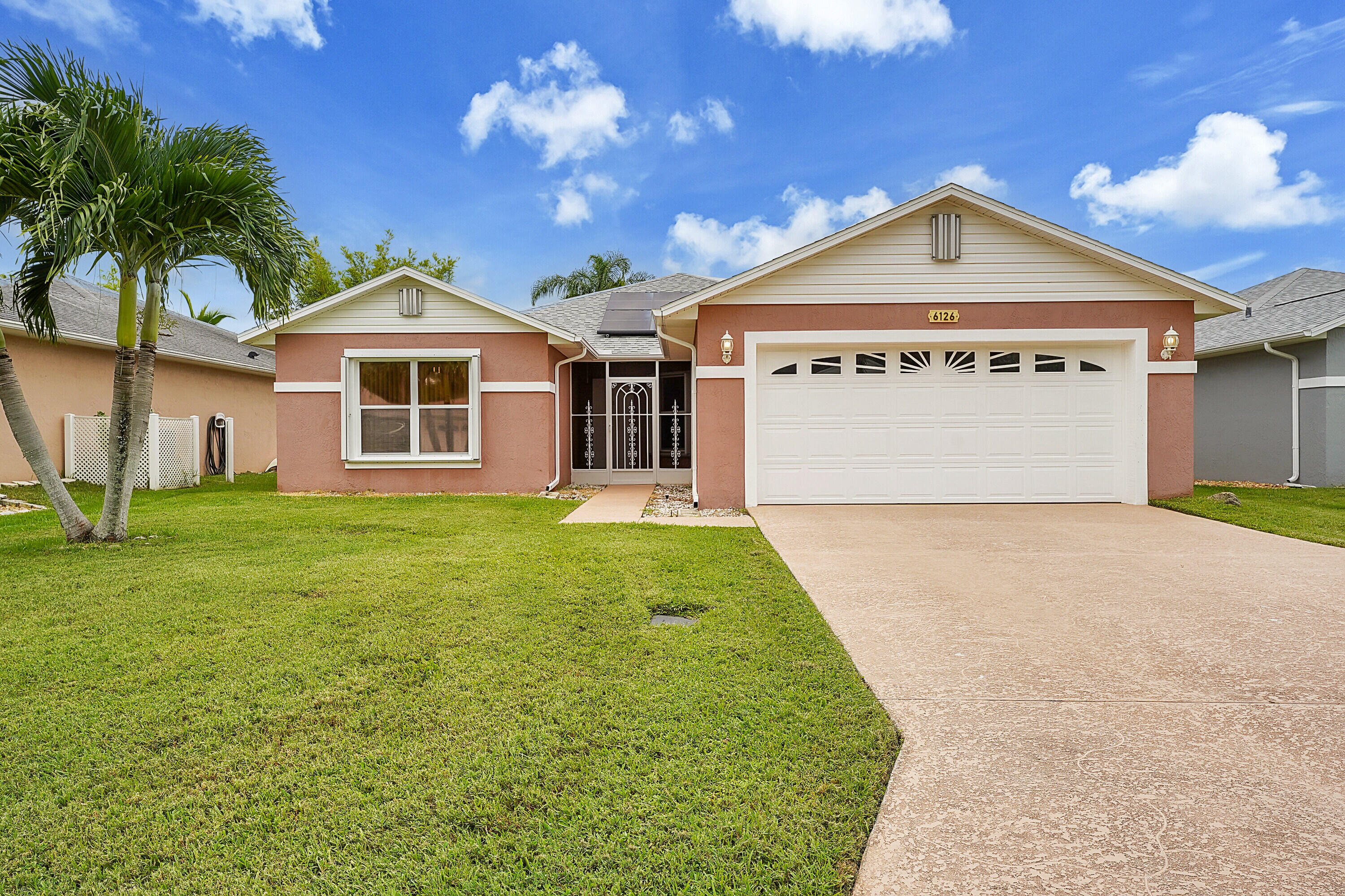 a front view of a house with a yard and garage