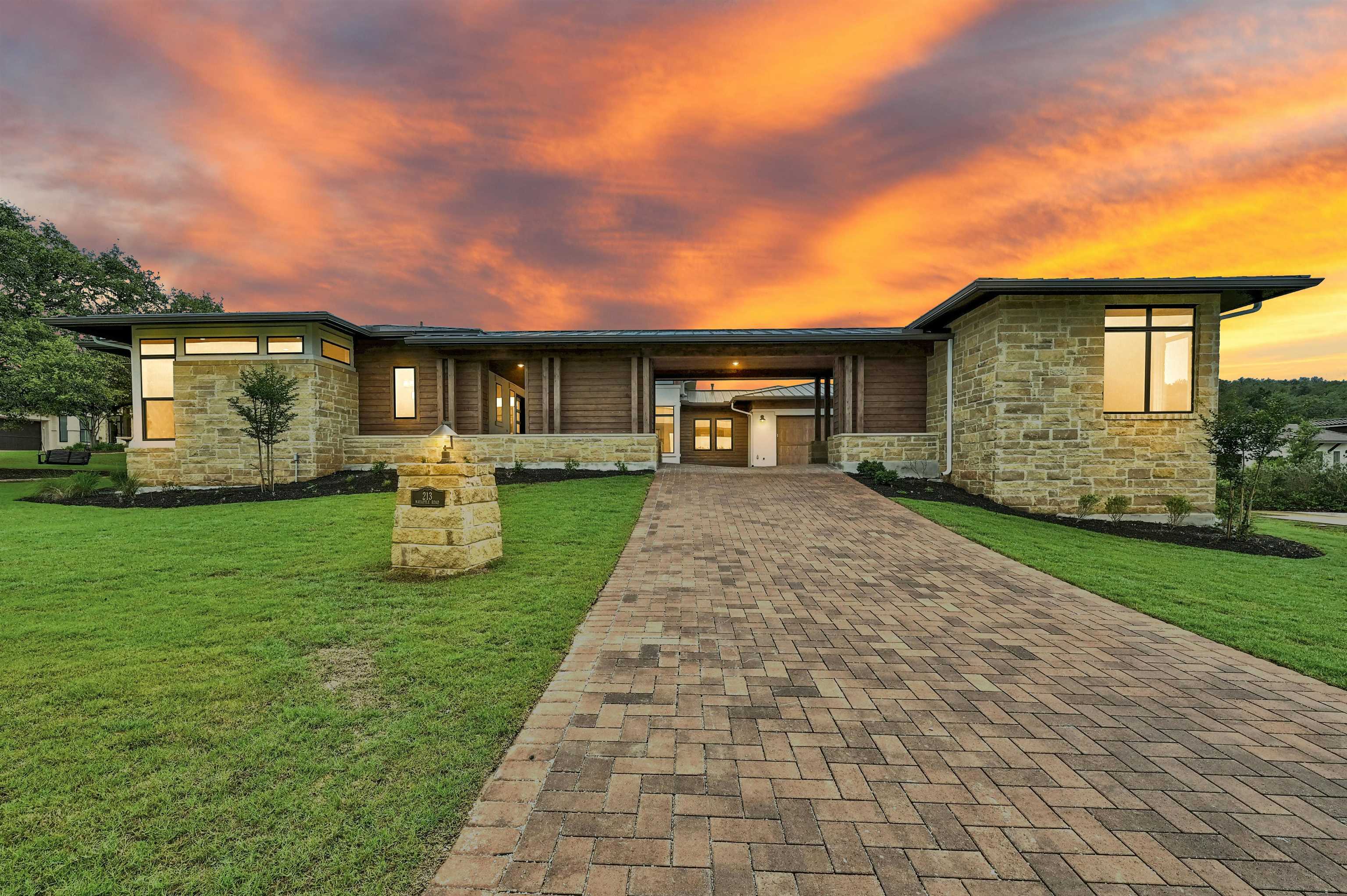 a front view of house with yard and green space