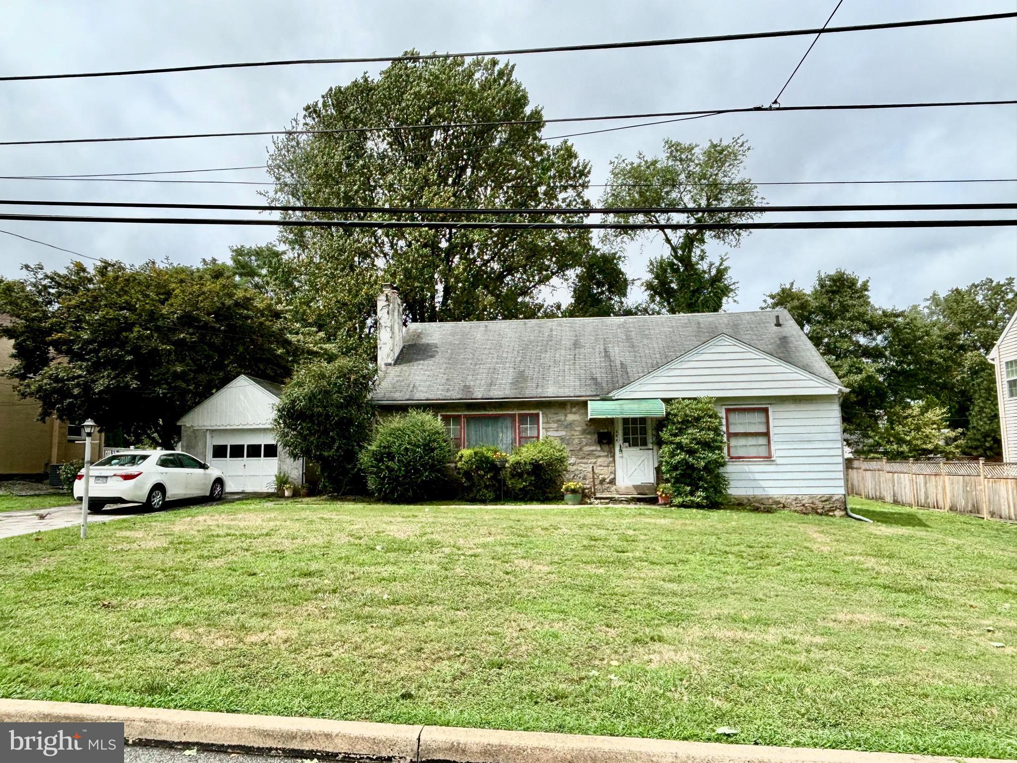 a view of a house with a yard and sitting area