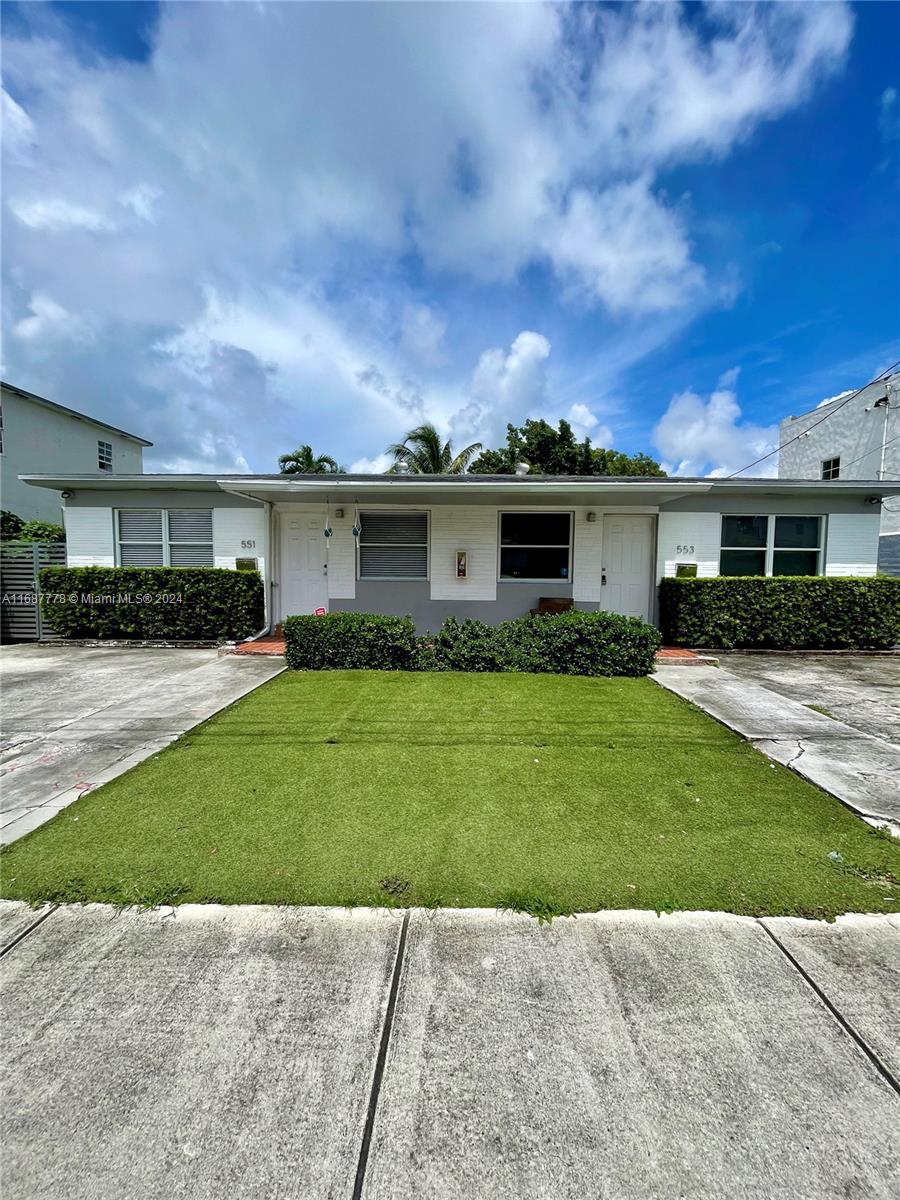 a view of a house with a backyard