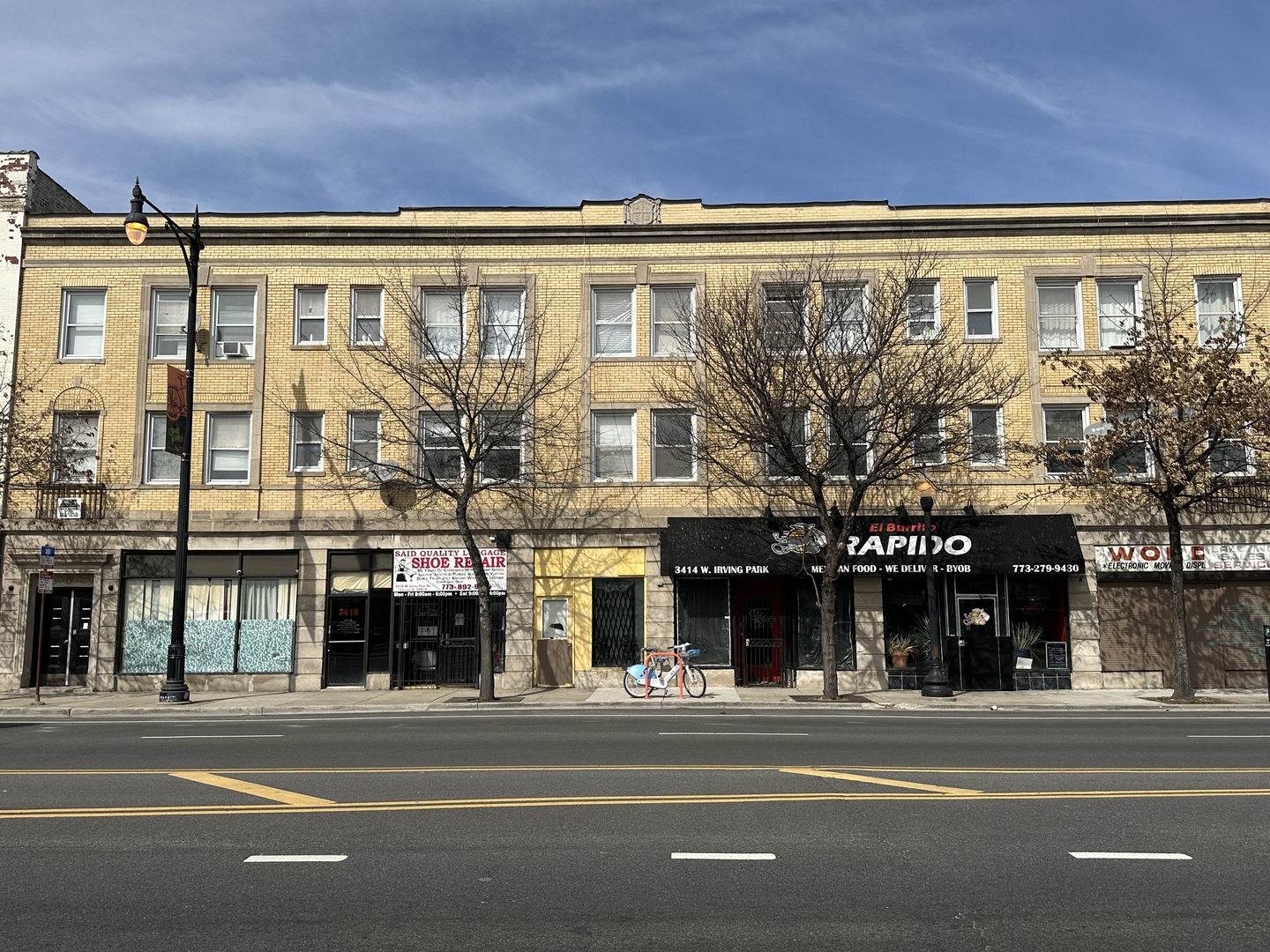 a view of a building and a people on a street