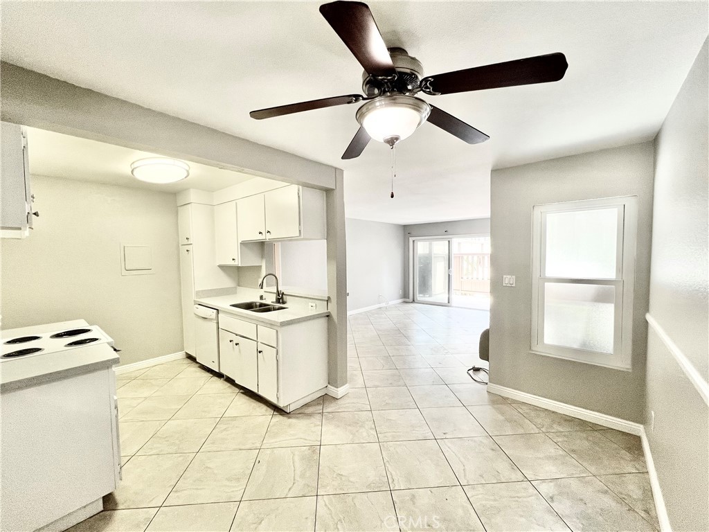 a kitchen with stainless steel appliances kitchen island granite countertop a stove a sink and a refrigerator