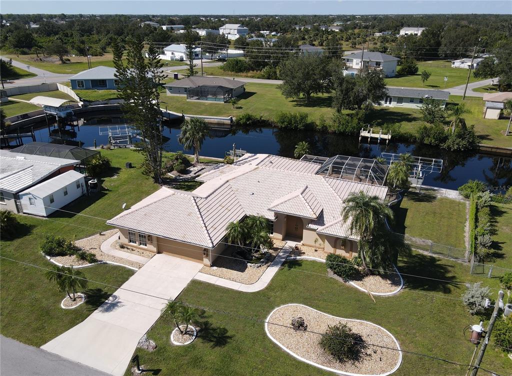 an aerial view of a house with yard swimming pool and outdoor seating