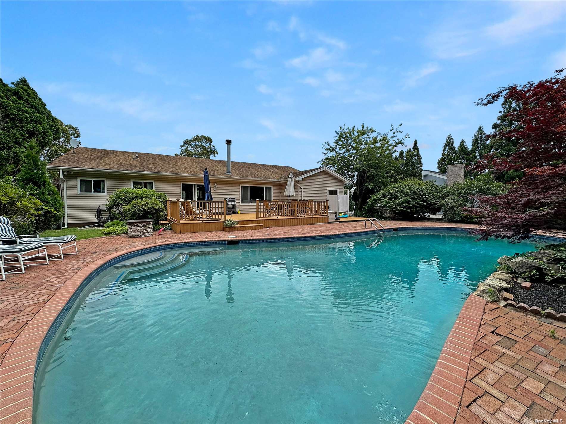 a swimming pool with outdoor seating and yard