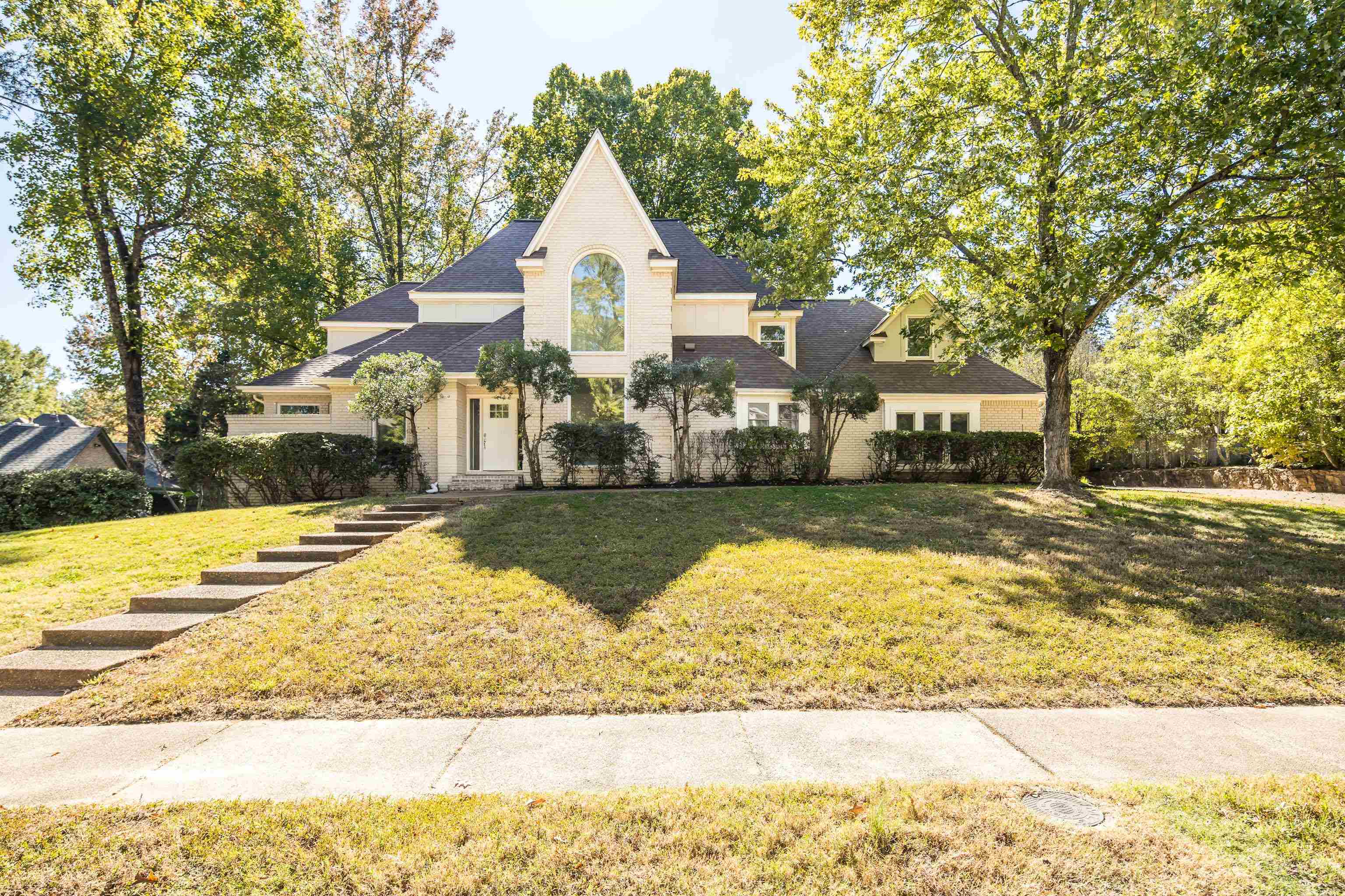 French provincial home featuring a front lawn