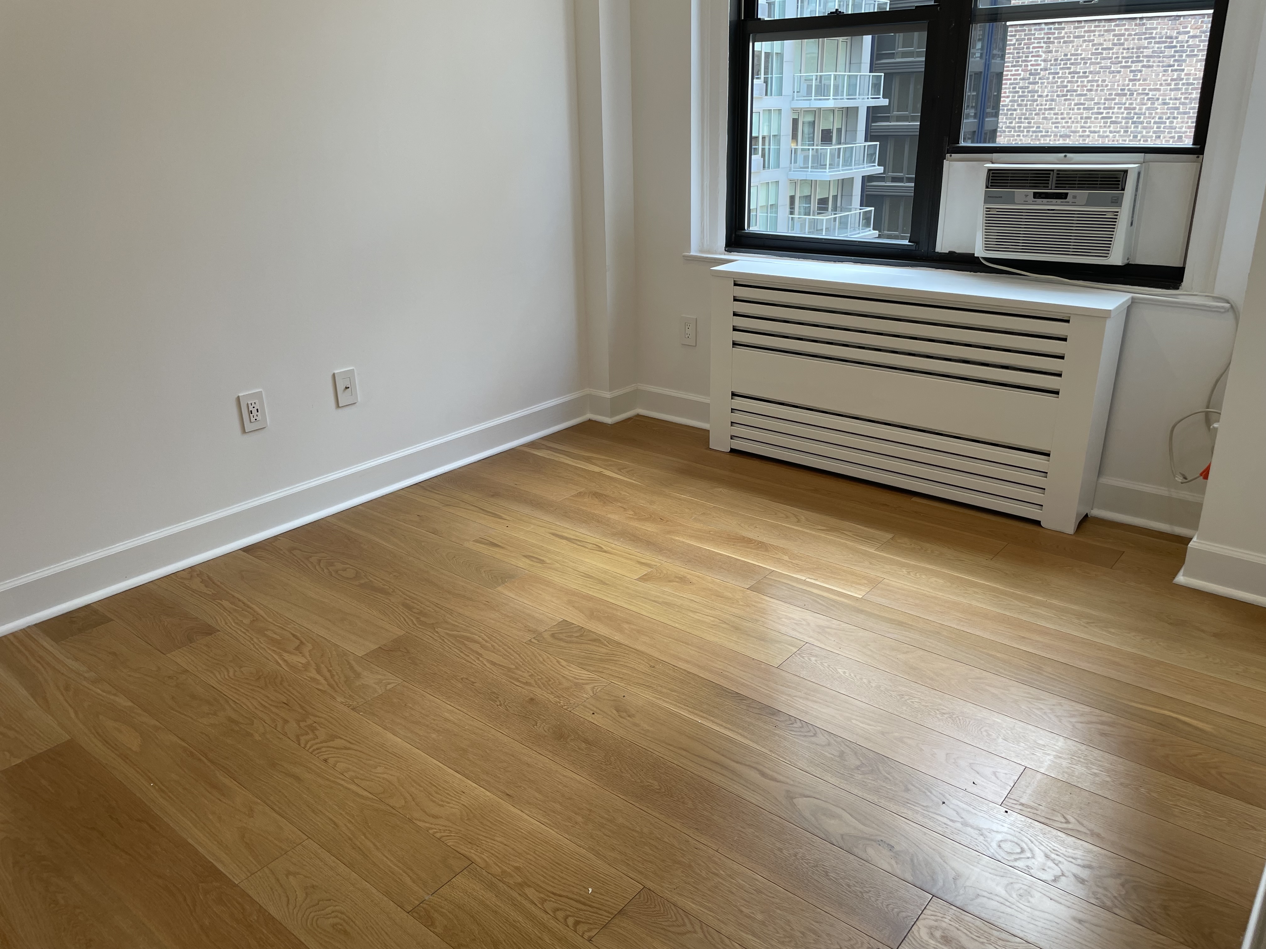 a view of a room with wooden floor