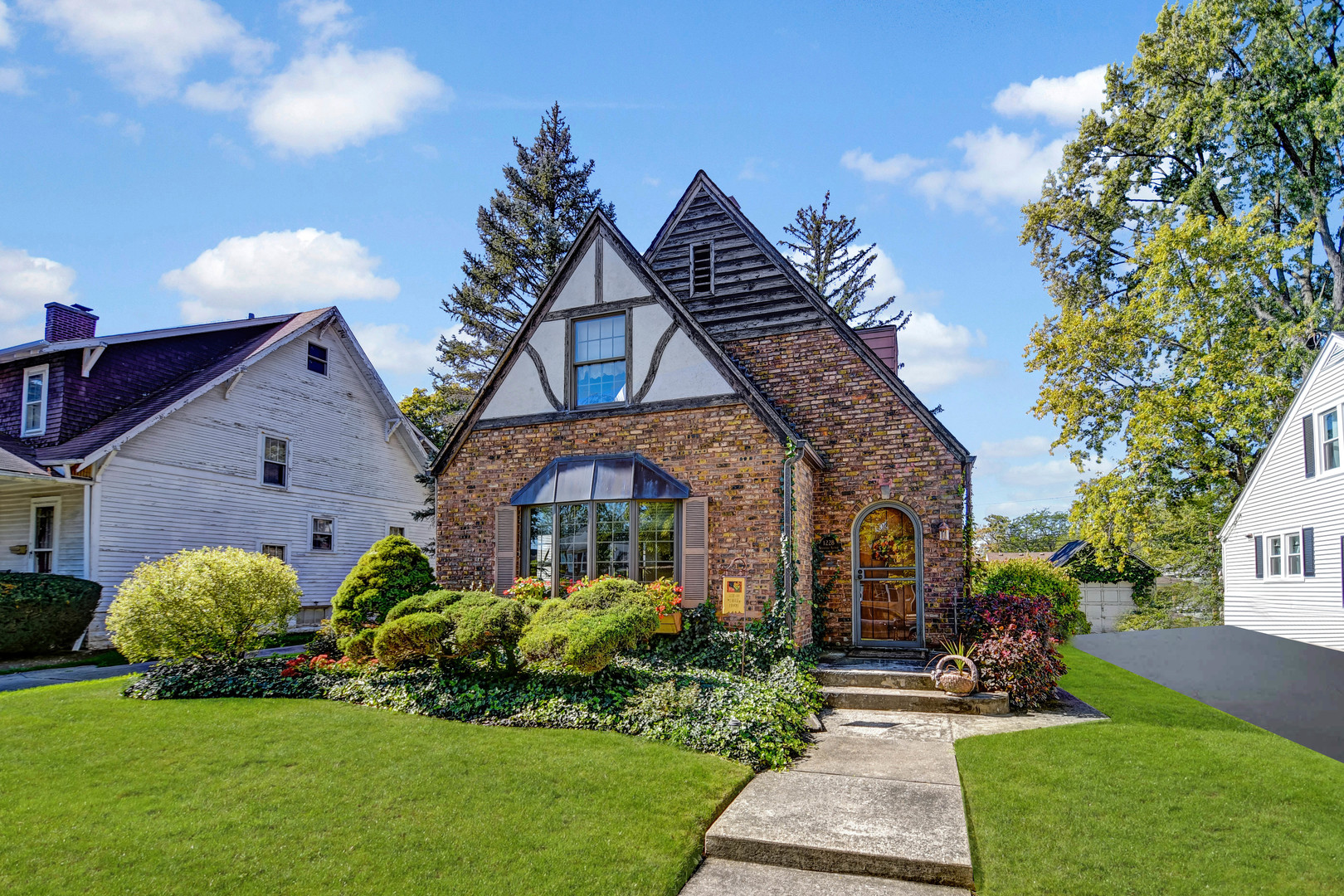 a front view of a house with a garden