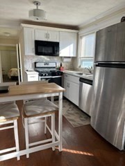 a kitchen with granite countertop a stove and a refrigerator