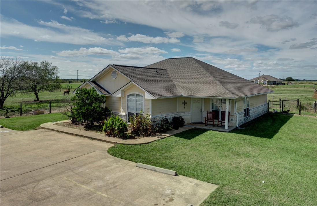 a front view of house with yard and green space