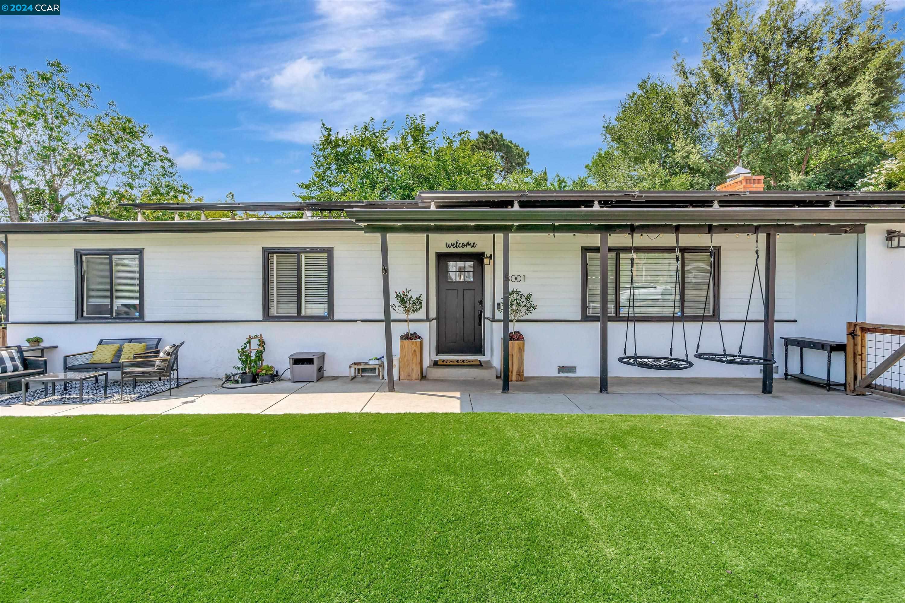 a house view with a sitting space and garden