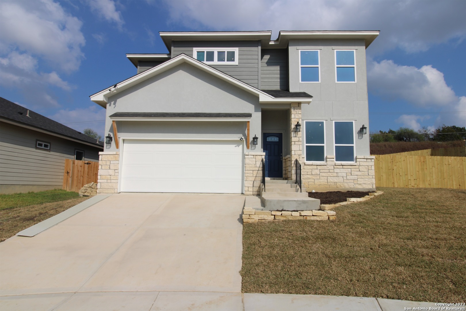 a front view of a house with a yard and garage