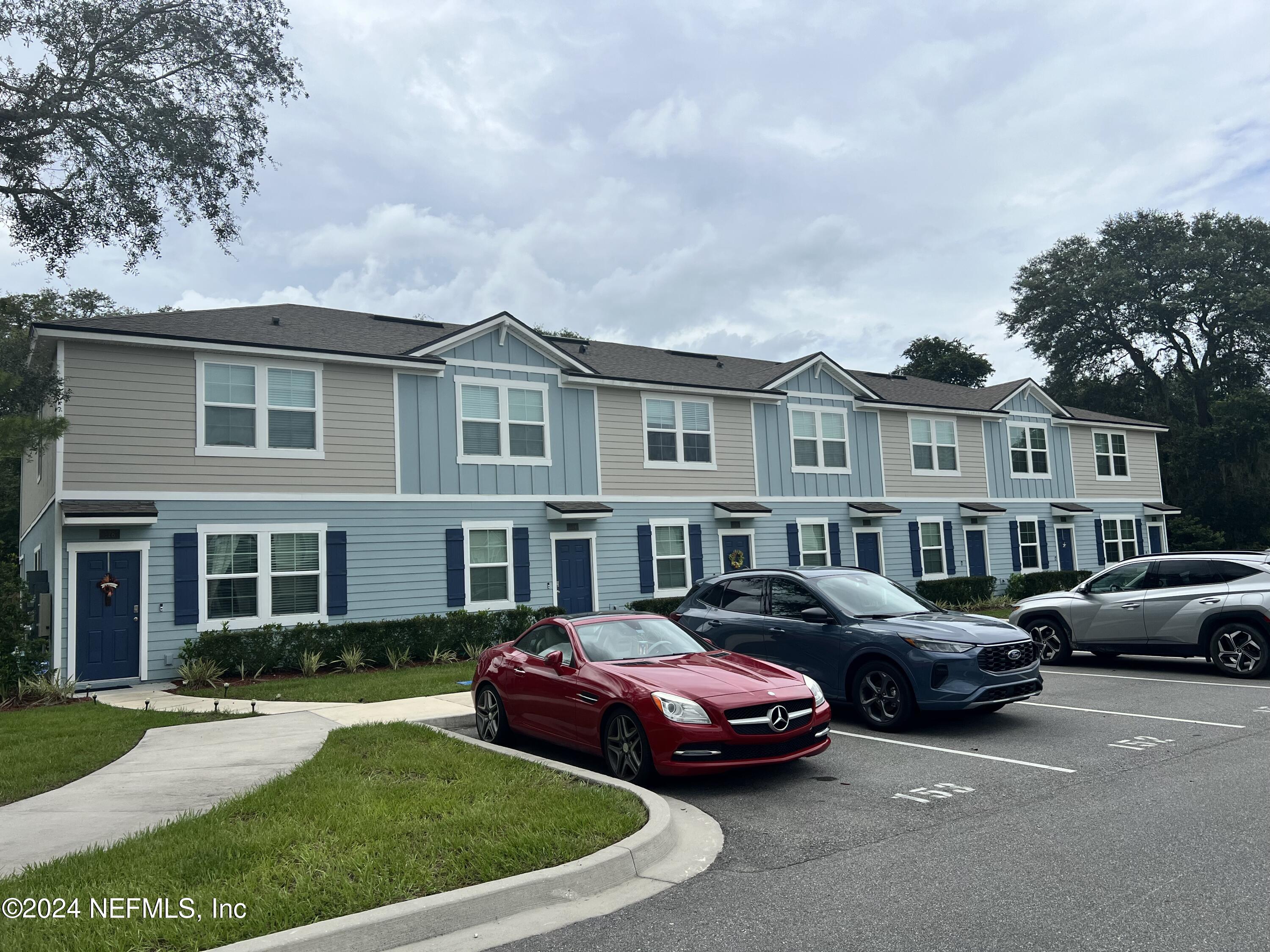 a couple of cars parked in front of a house