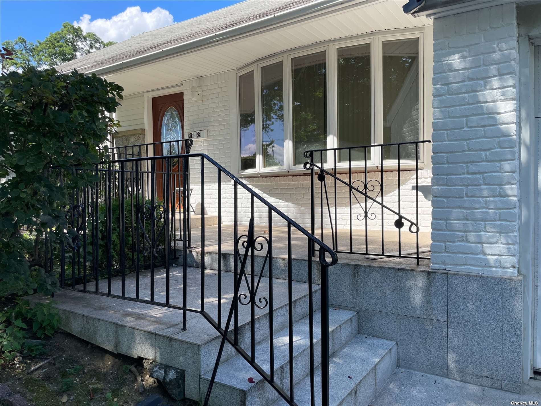 a view of staircase with railing and a potted plant