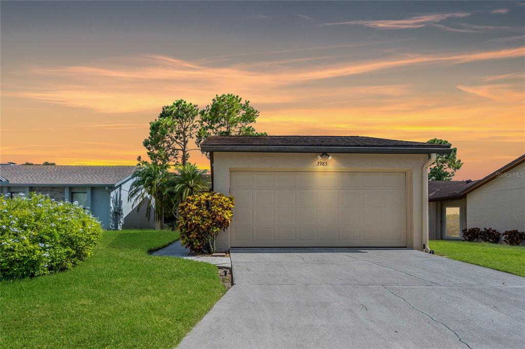 a view of a house with a yard and garage