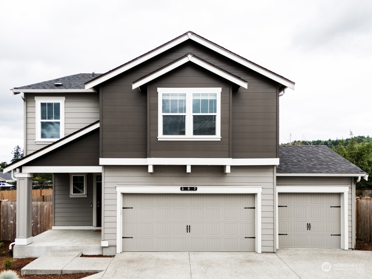 a front view of a house with garage