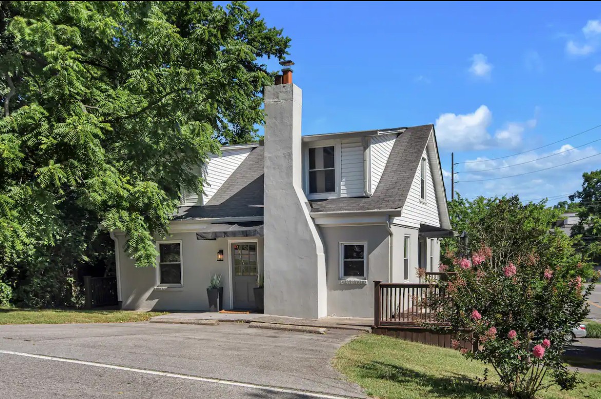 a front view of a house with a garden