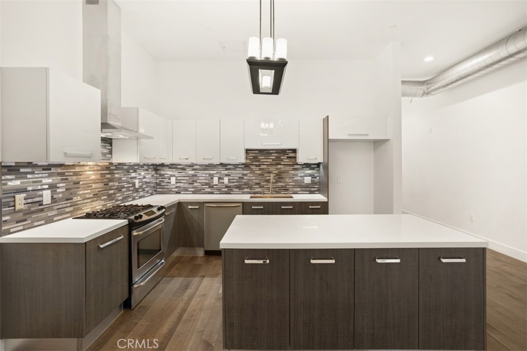 a kitchen with stainless steel appliances granite countertop a sink stove and cabinets