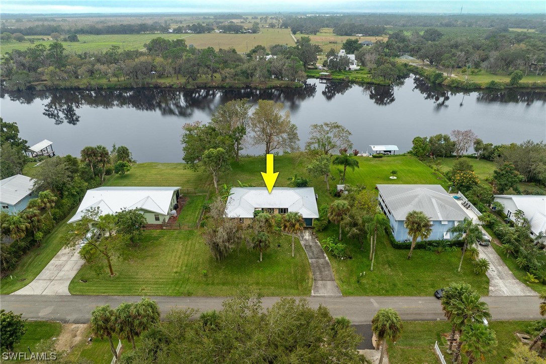 an aerial view of lake residential house with swimming pool and green space