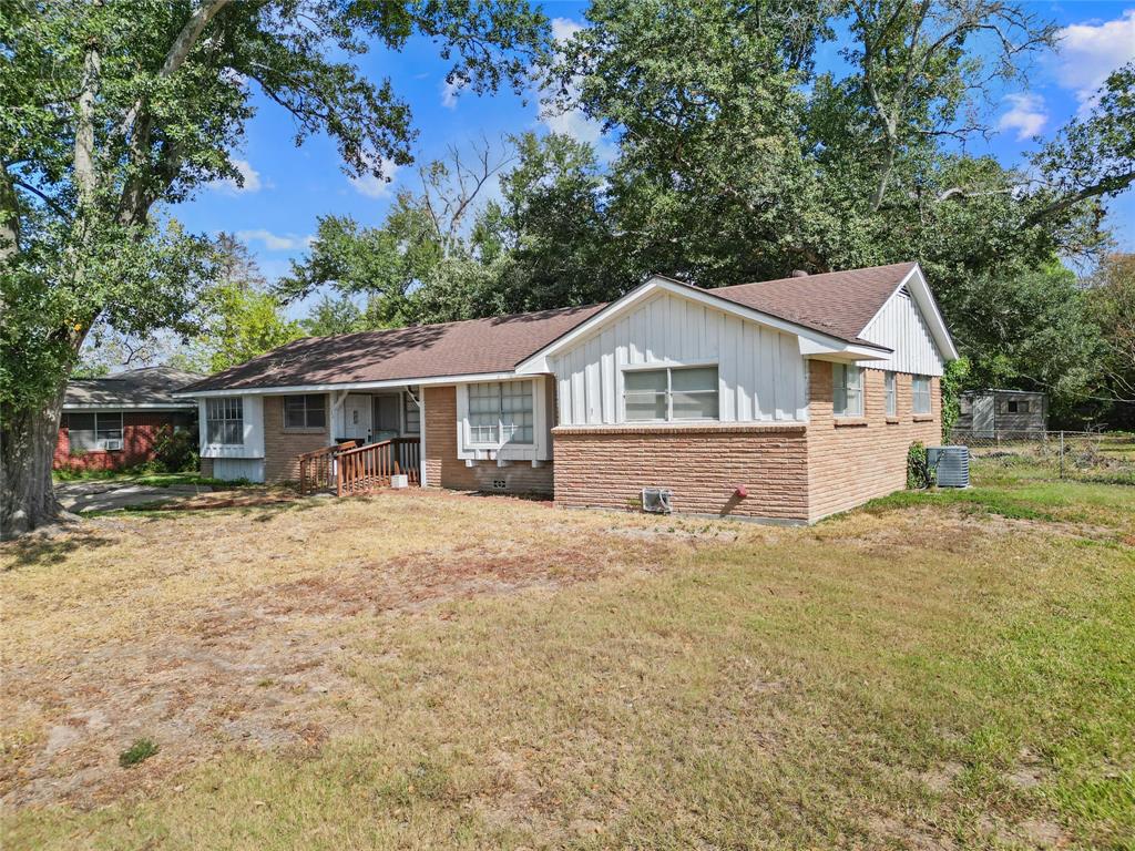 a front view of a house with a yard and trees