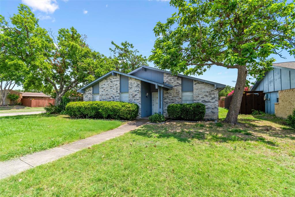 a view of a house with a yard and tree s