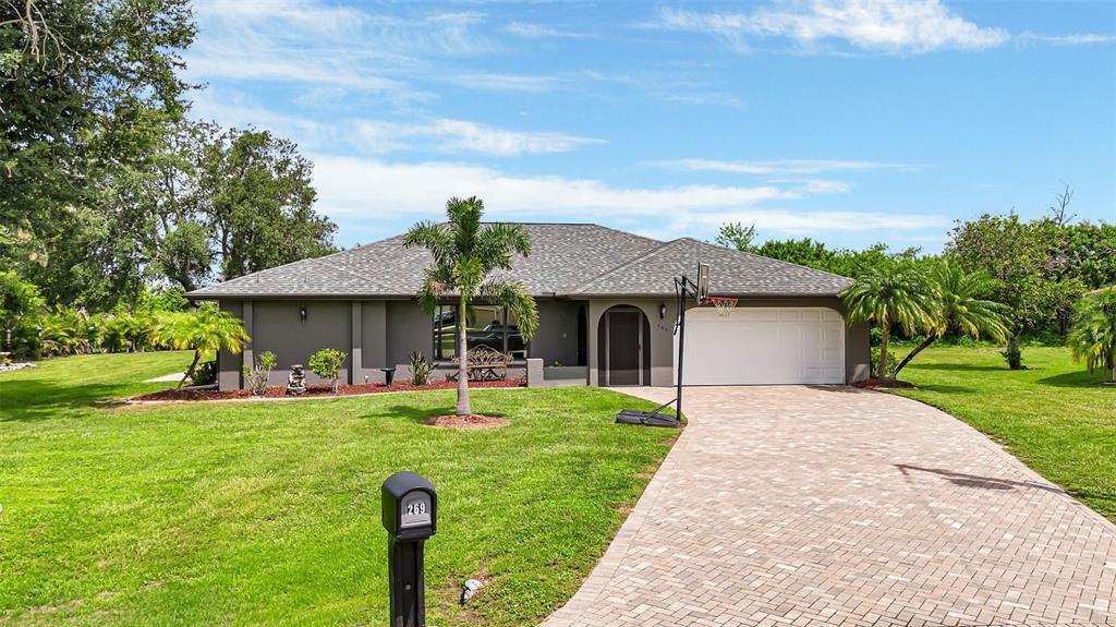 a front view of house with yard and trees