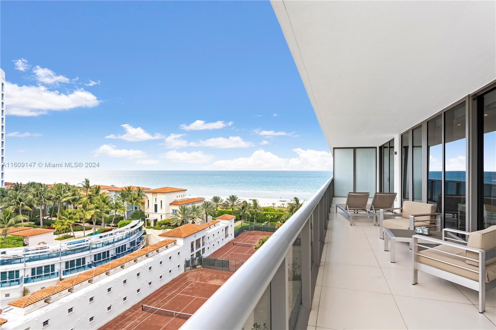 a balcony with chairs and city view