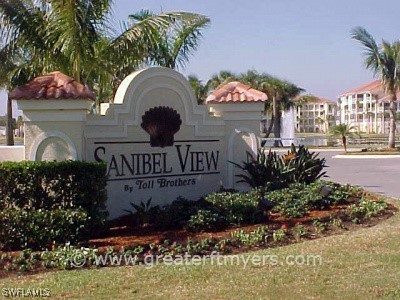 a front view of a house with a yard and fountain in middle