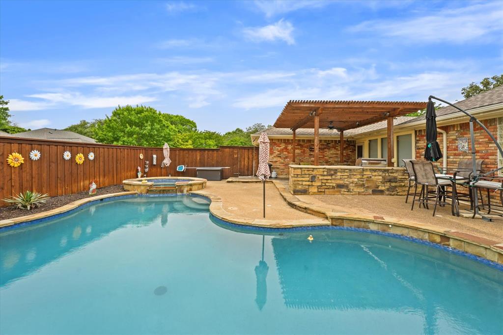 an aerial view of a house with swimming pool having outdoor seating