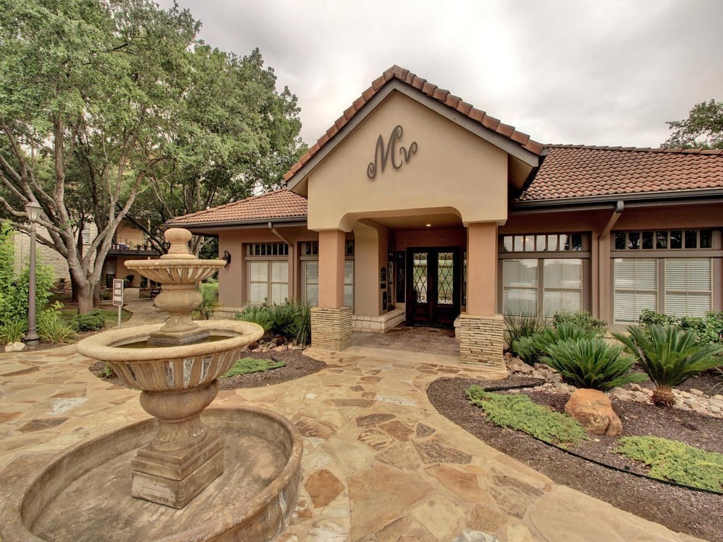 a front view of a house with garden and patio