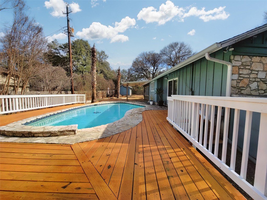 a view of swimming pool with deck and outdoor seating