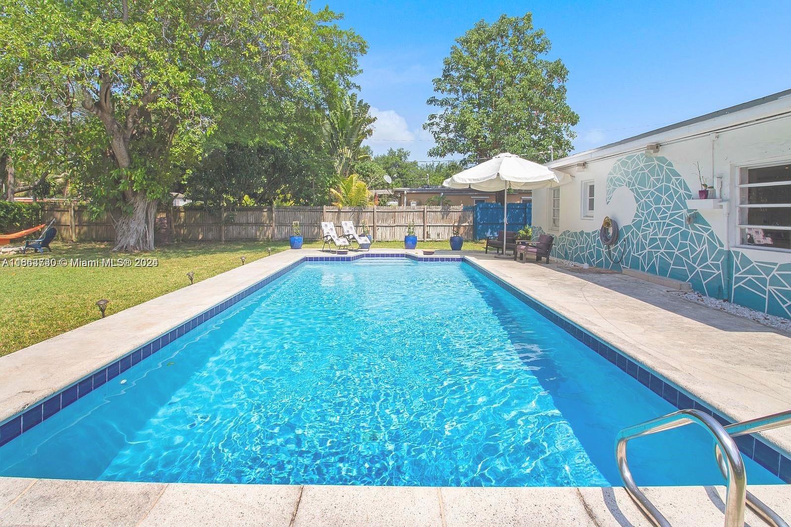 a swimming pool with outdoor seating and yard