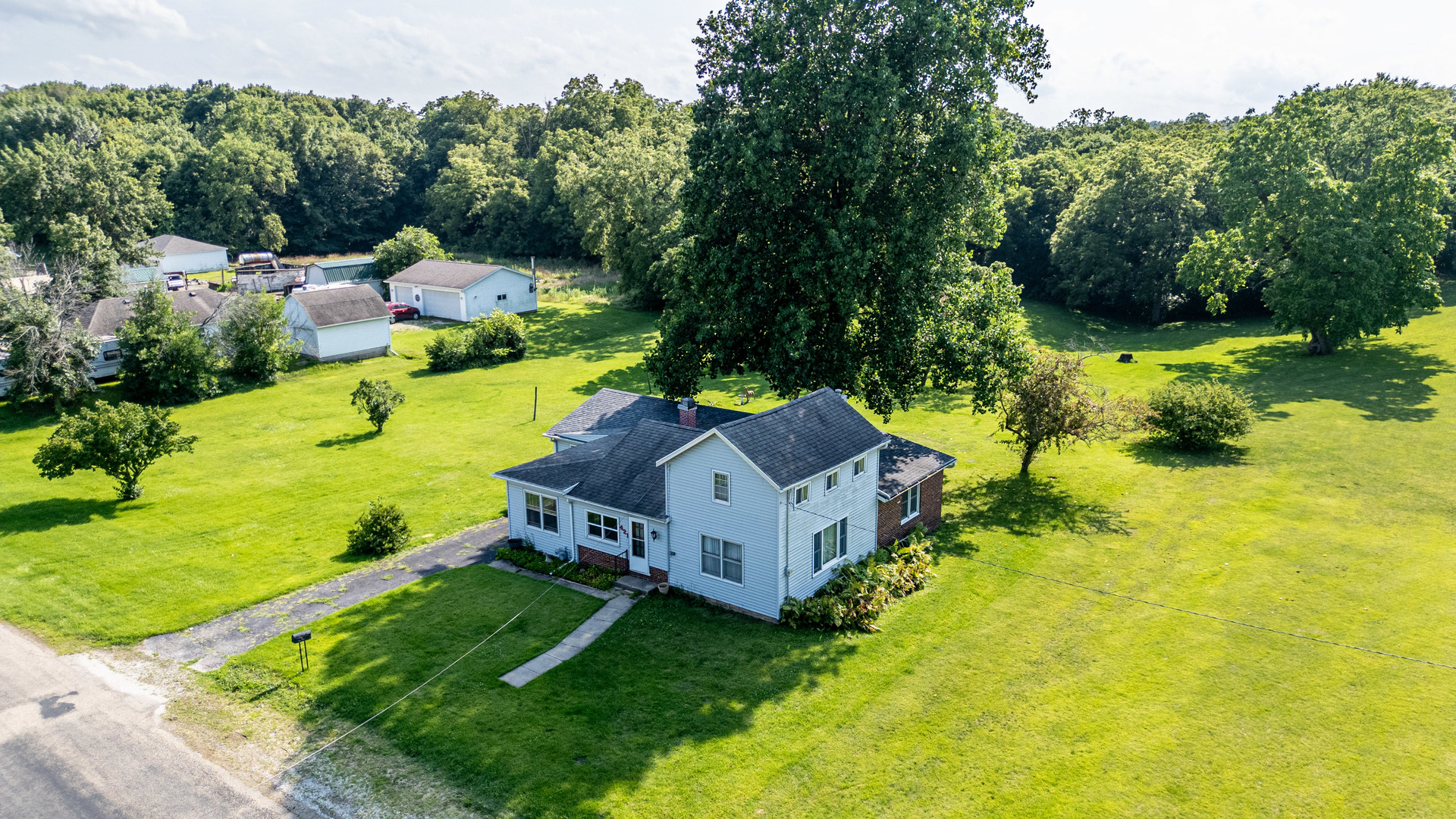 an aerial view of a house with a yard basket ball court and outdoor seating