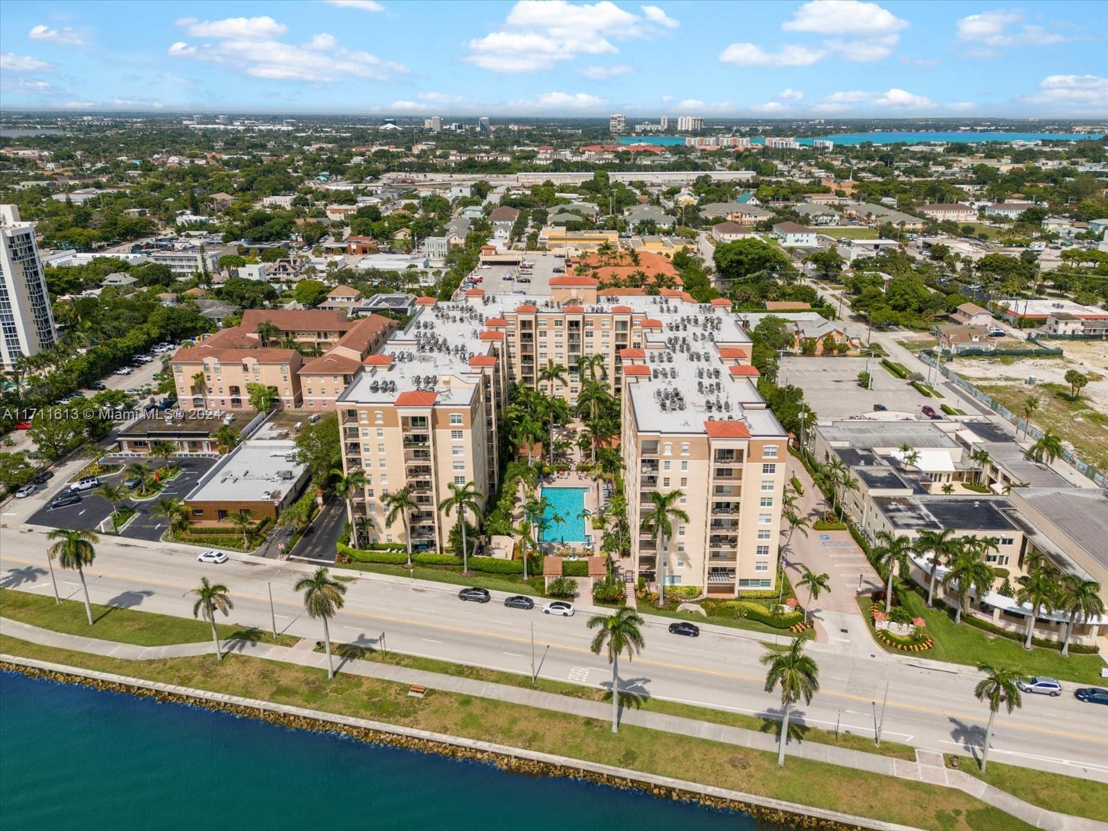 an aerial view of residential houses with outdoor space and ocean view