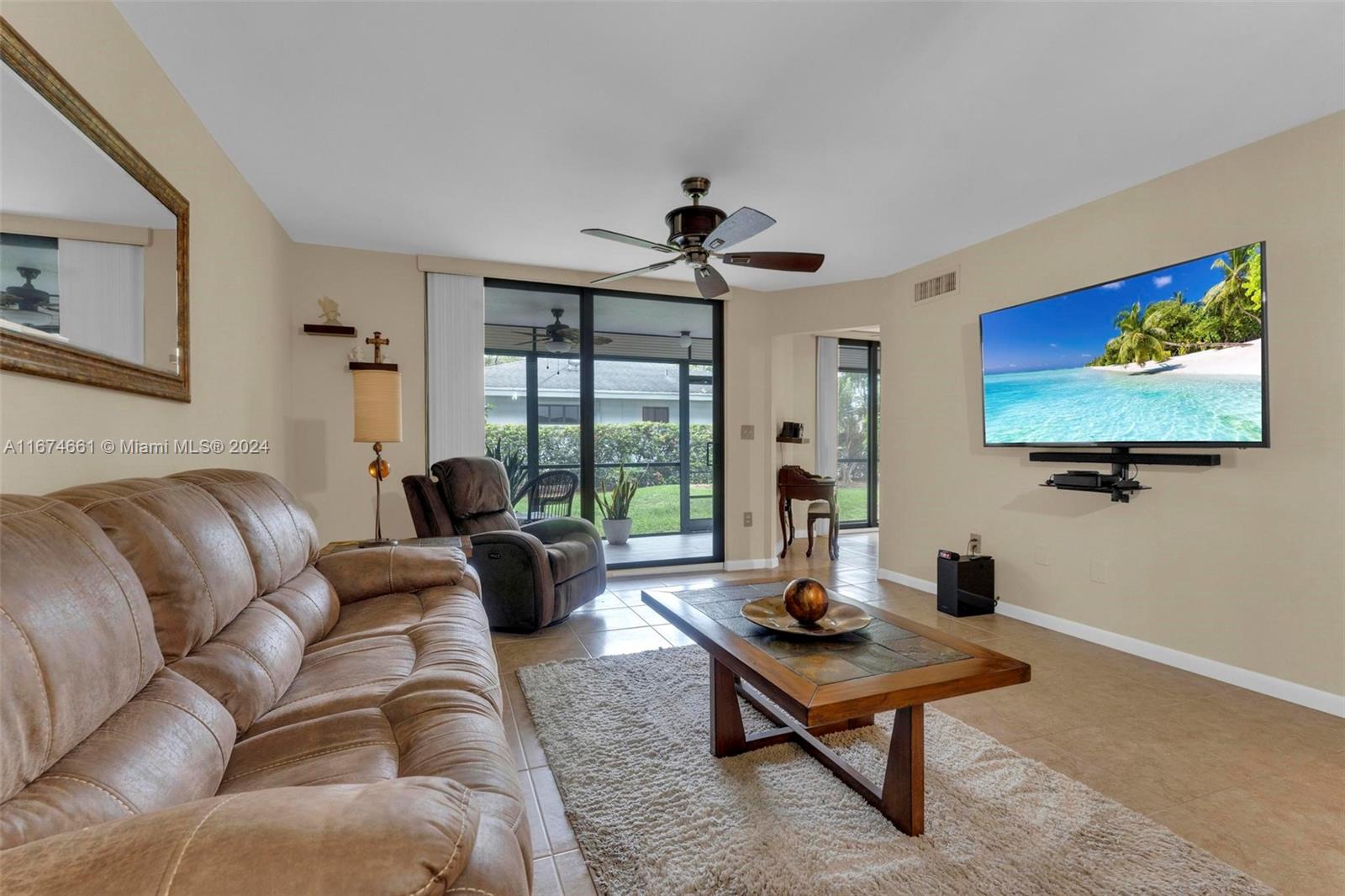 a living room with furniture a rug and a large window