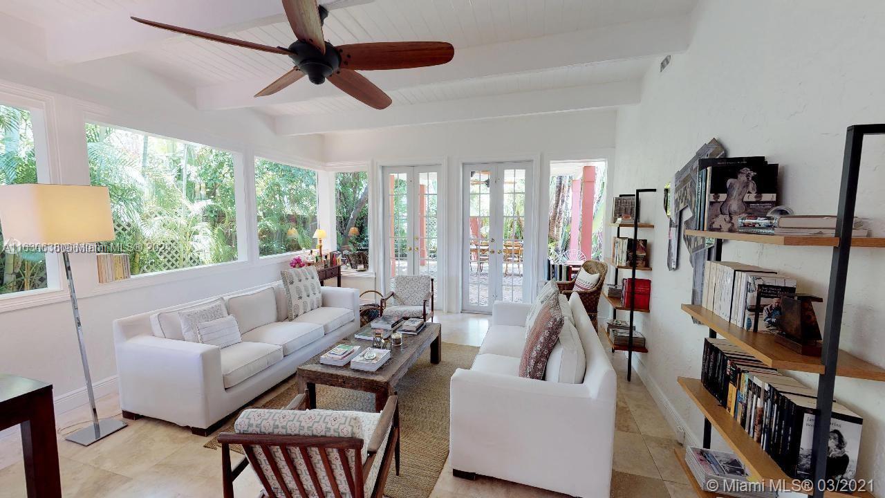 a living room with furniture flat screen tv and a large window