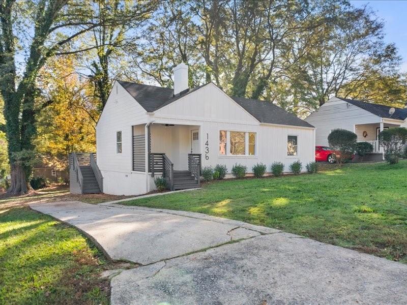 a front view of house with yard and green space