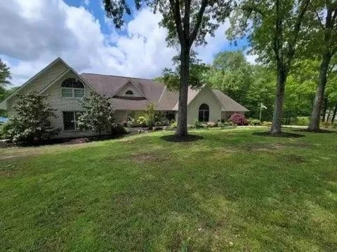 a front view of house with yard and green space