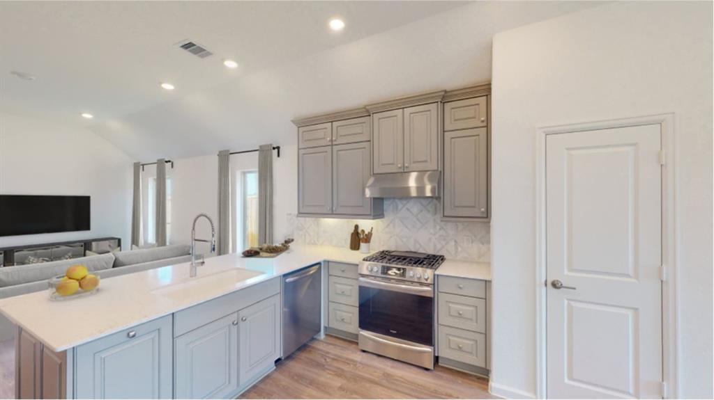 a kitchen with a sink stove and cabinets