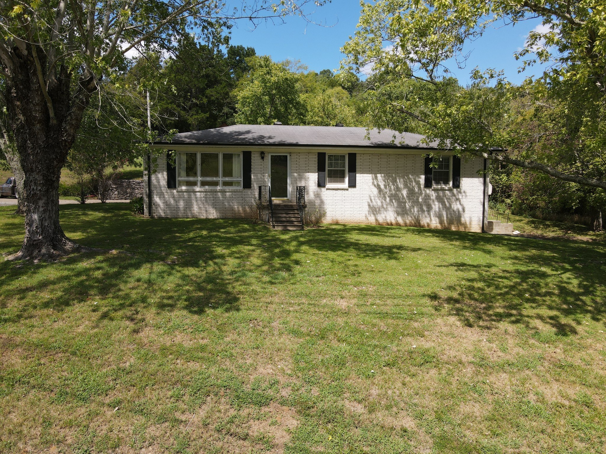 a front view of a house with a garden