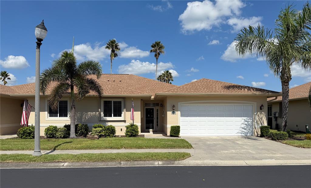 a front view of a house with a yard and garage