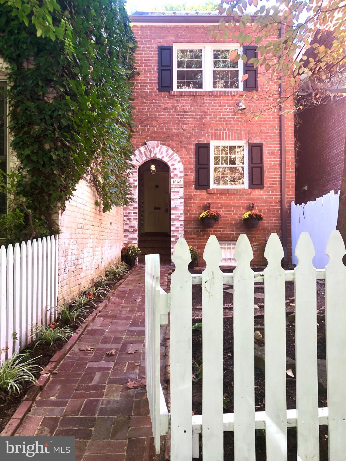 a front view of a house with wooden fence