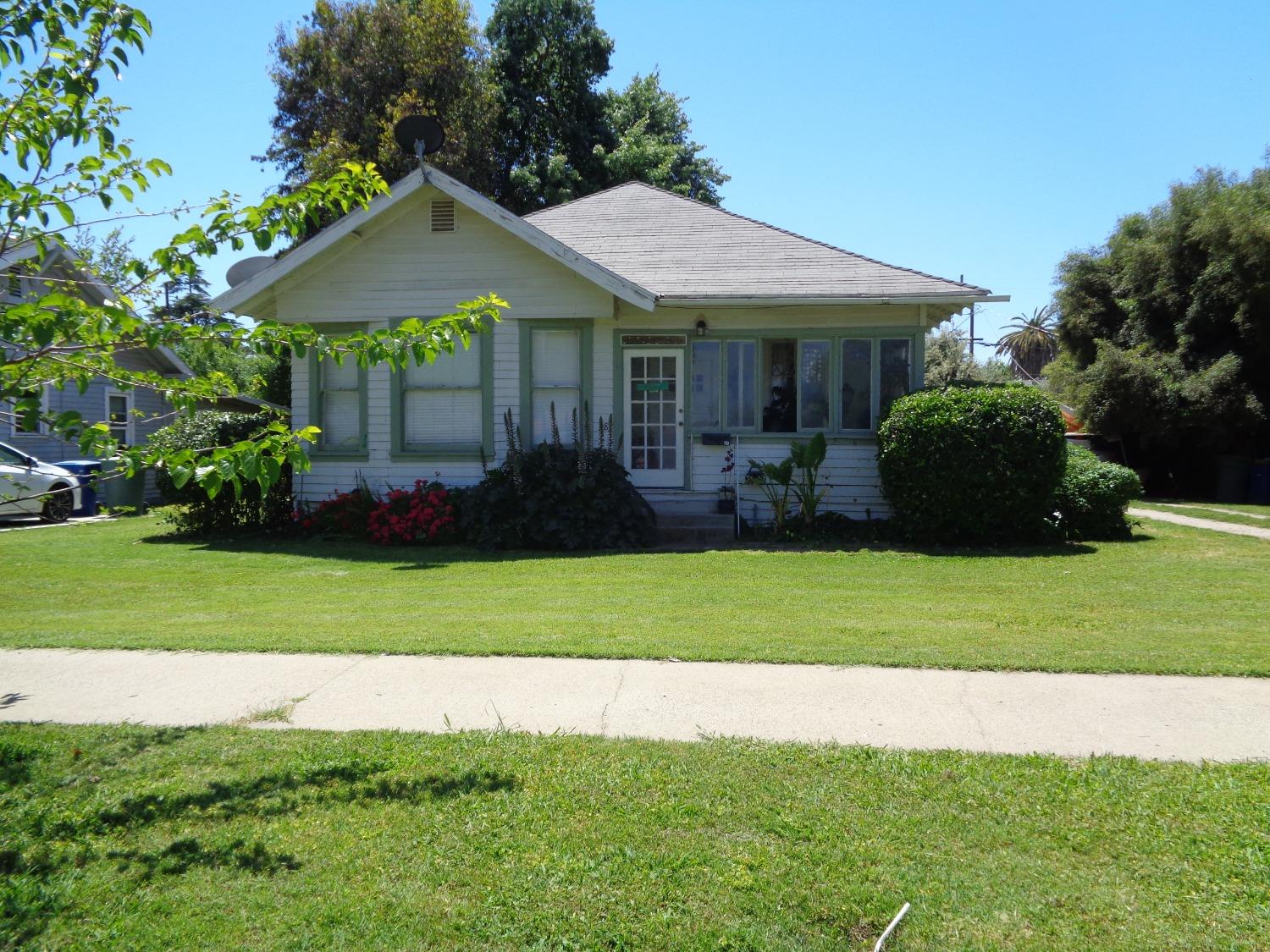 a front view of a house with a garden