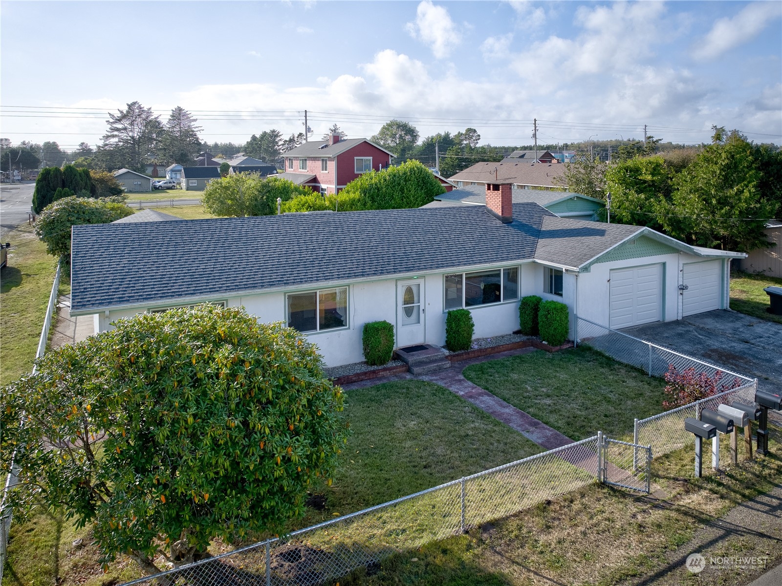 a aerial view of a house next to a yard