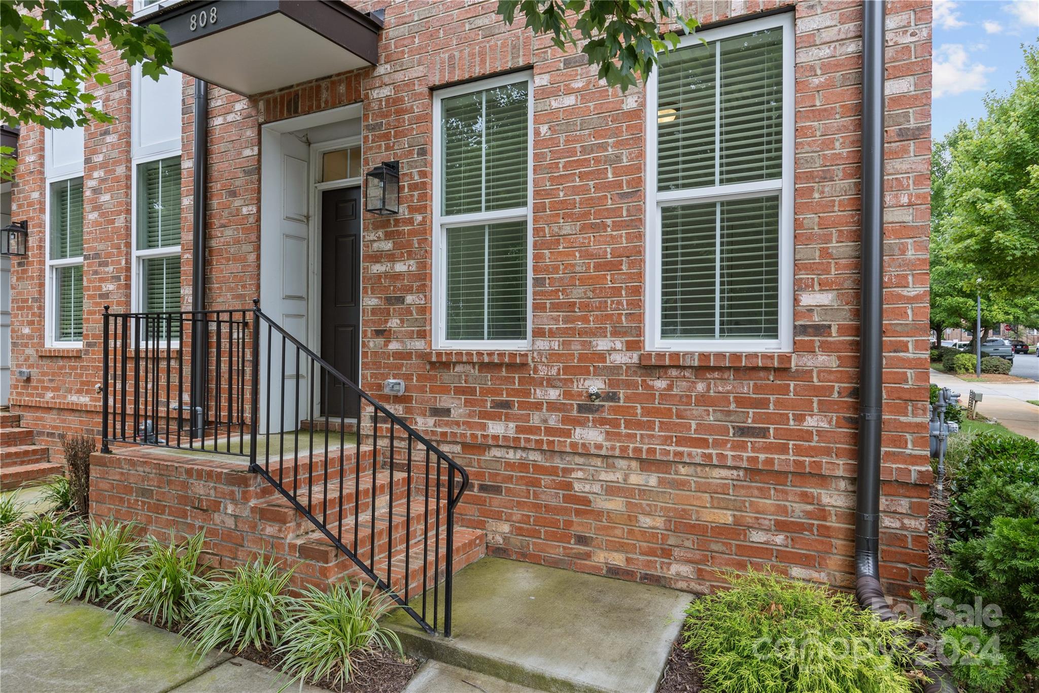 a view of a brick house with a small porch