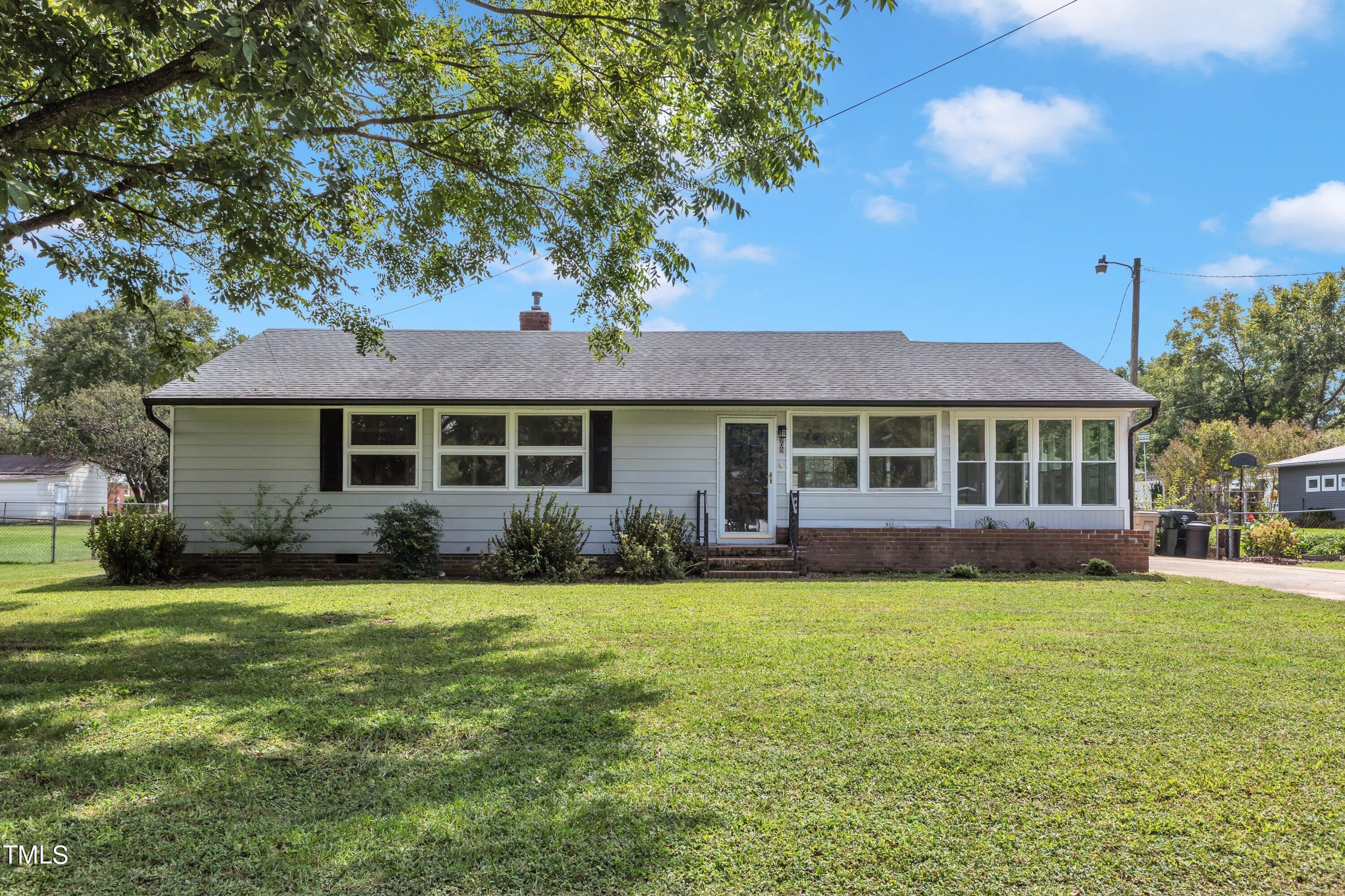 a front view of a house with a garden and porch