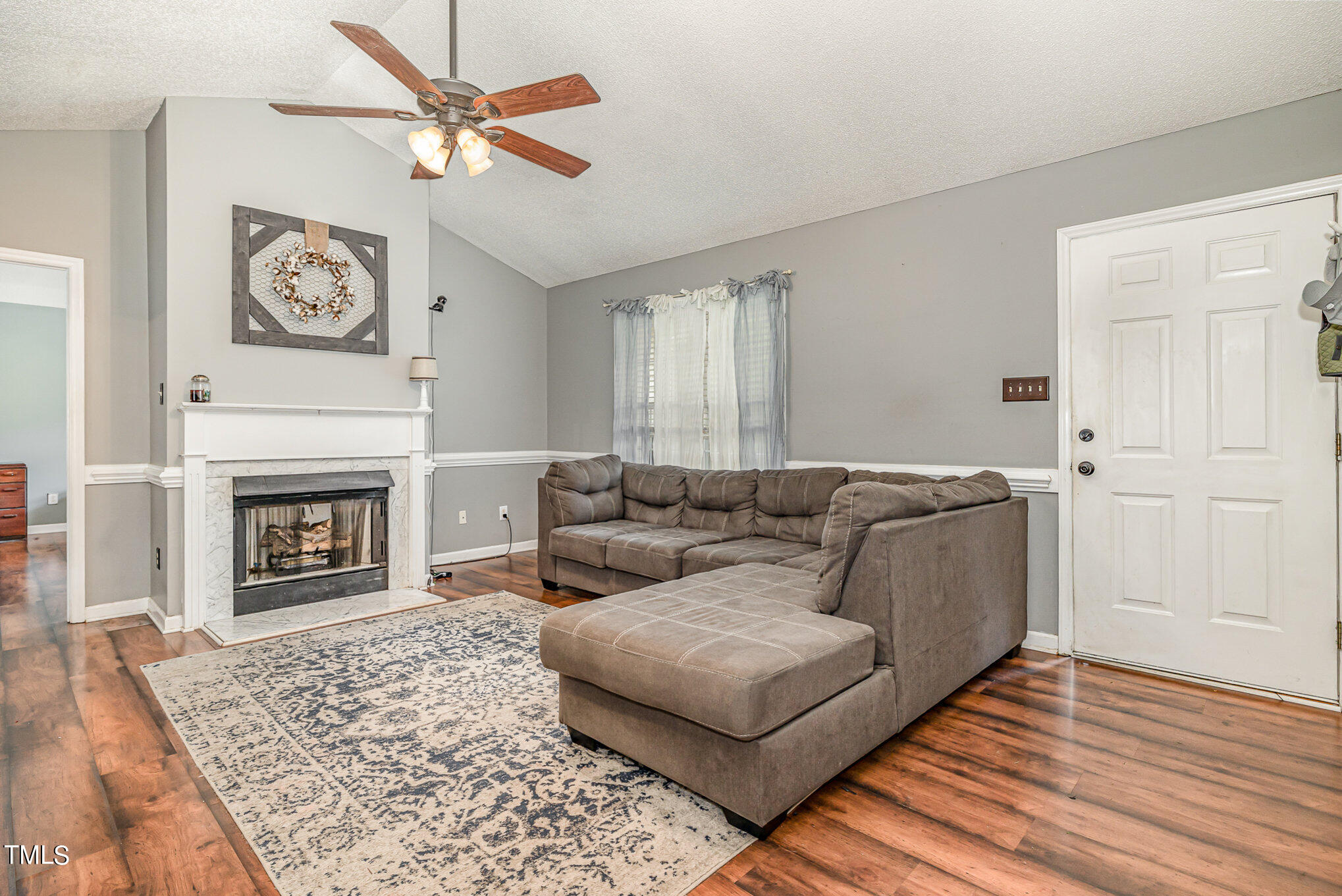 a living room with furniture and a fireplace