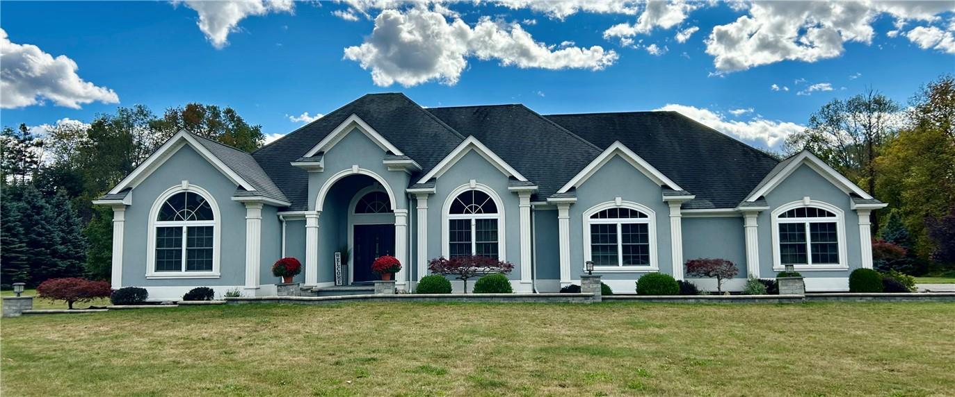 a front view of a house with a garden